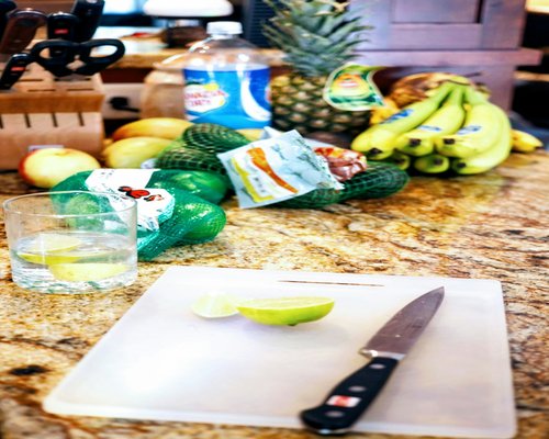 Glass of water and healthy fresh ingredients in a brightly lit kitchen